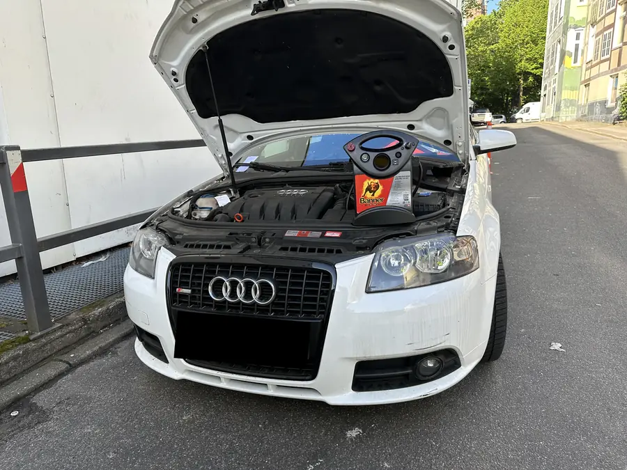 Starthilfe mit Booster an einem Auto mit geöffneter Motorhaube in Hamburg